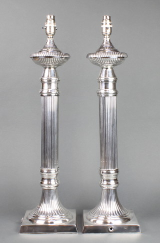 A pair of  plated column table lamps on square bases 24" 
