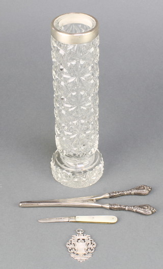 A silver sports fob, a pair of handled glove stretchers, a silver fruit knife and a mounted cut glass jar 