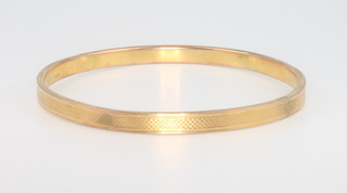 A 9ct yellow gold engine turned bangle 10 grams