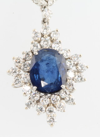 An 18ct white gold sapphire and diamond pendant, the centre stone approx 4.6ct surrounded by brilliant cut diamonds approx. 1.8ct 
