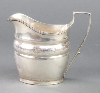 A George III silver cream jug with chased floral decoration and monogram, with vacant cartouche, London 1801, 122 grams
