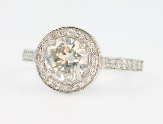 A platinum single stone diamond ring approx. 1.5ct surrounded by brilliant cut diamonds approx. 0.32ct, size M 1/2