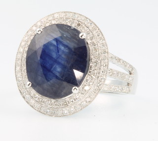 A 14ct white gold sapphire and diamond cocktail ring, the centre stone approx. 6.75ct surrounded by brilliant cut diamonds approx. 1.1ct size M  1/2