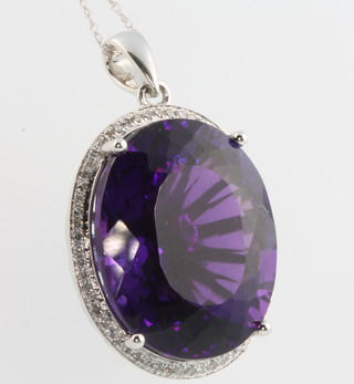 A 14ct white gold amethyst and diamond pendant, the amethyst approx. 24ct surrounded by 0.30ct diamonds  