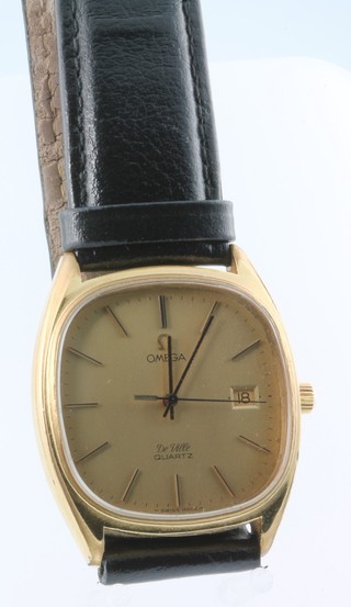 A gentleman's gilt cased quartz Omega de Ville calendar wristwatch on a leather strap 