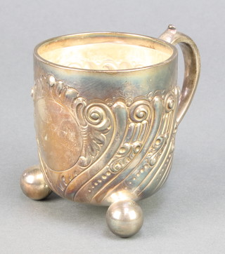 A Victorian repousse silver mug with scroll decoration and vacant cartouche on ball feet London 1888, 178 grams 4" 