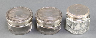 A pair of silver topped engine turned toilet jars Birmingham 1924, a Sterling octagonal ditto 