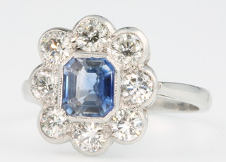 A platinum sapphire and diamond cluster ring, the centre stone approx. 1.1ct surrounded by 8 brilliant cut diamonds approx 1.2ct, size O 1/2