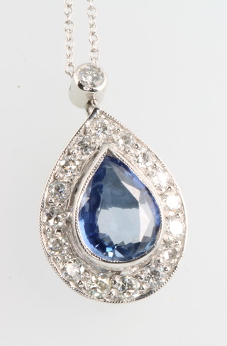 A sapphire and diamond pear shaped pendant the pear shaped sapphire approx. 3.35ct, surrounded by 16 brilliant cut diamonds supported by 1 brilliant cut diamond approx. 07.5ct on an 18ct white gold chain 