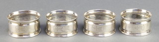 A set of 4 Victorian silver napkin rings with engine turned decoration, 52 grams 