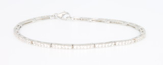 A silver paste set line bracelet