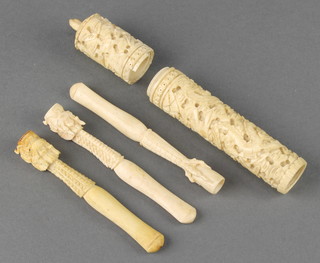 A carved bone cigarette holder in the form of a dragon, 2 others and a needle case 