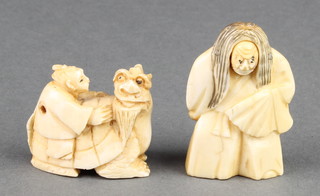 A carved ivory Netsuke in the form of an actor holding a fan, a ditto of a boy seated on a giant dragon, signed 1" 