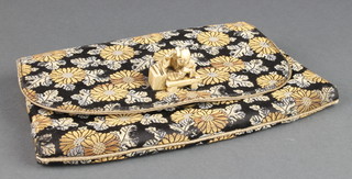 A Japanese silk work evening bag, the handle in the form of a Japanese Netsuke of a workman 