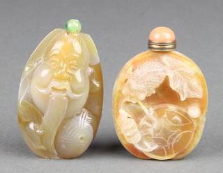 A Chinese carved agate scent bottle in the form of a deity 3" together with a ditto carved with a carp amongst seaweed 2 3/4" 