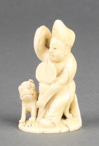 A late 19th Century carved ivory Okimono in the form of a man with a dog 2" 