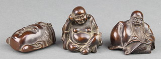 A carved fruitwood Netsuke in the form of a mask, signed, 1 3/4", 2 others in the form of seated gentlemen 2" 