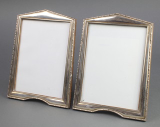 A pair of silver photographs frames with repousse borders Birmingham 1946 9 1/2" 
