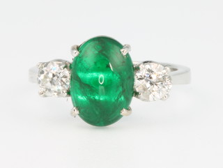 An 18ct yellow gold emerald and diamond ring, the oval cabochon cut emerald flanked by brilliant cut diamonds, size L