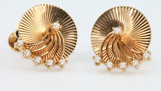 A pair of 14ct yellow gold seed pearl ear studs with swivel disc mounts, stamped Cartier 