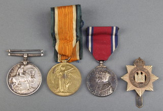 A World War I pair of medals to 5545 Pte. M.Strachan. A & S.H, together with a 1935 commemorative medal and badge 