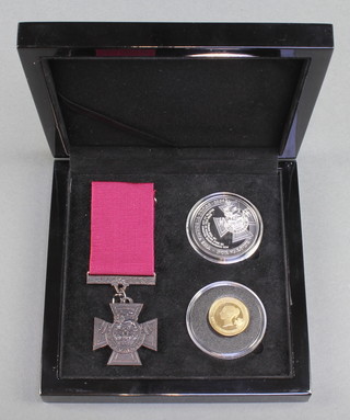 The Victoria Cross gold and silver commemorative set comprising a replica Victoria Cross, a silver crown and a 9ct gold 24ct gold plated commemorative coin 2.8 grams, cased 