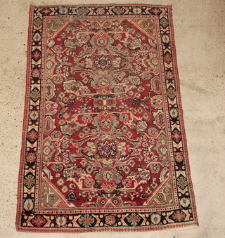 A pink ground and floral patterned Persian rug 80" x 49"