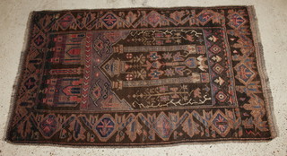A Baluchi brown and blue ground prayer rug decorated buildings 62" x 39" 