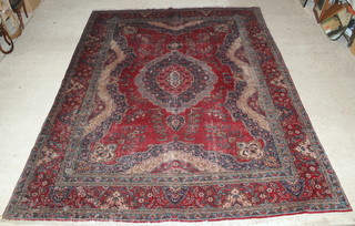 A Tabriz red and blue ground carpet with central medallion 157" x 118" 
