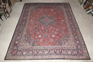 A Persian Kashan red and blue ground carpet with central medallion 170" x 130" 