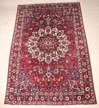 A Bakhtiari red and blue ground  carpet with central medallion 124" x 83" 
