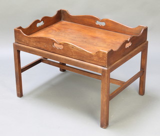 A rectangular butler's tray raised on a base with square tapered supports and H framed stretcher 21"h x 30"w x 22 1/2"d 