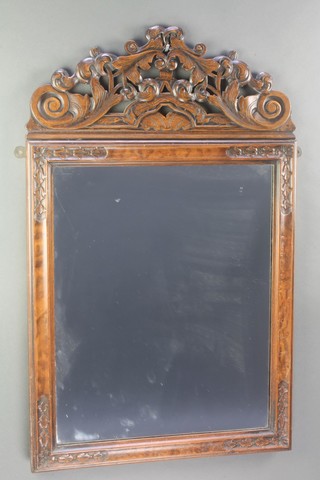 A Dutch style rectangular plate mirror contained in a carved walnut frame with pierced crest 34"h x 21" w 