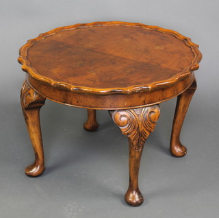 A Queen Anne style walnut circular occasional table with quarter veneered top and pie crust edge raised on cabriole supports 15"h x 20" diam.  