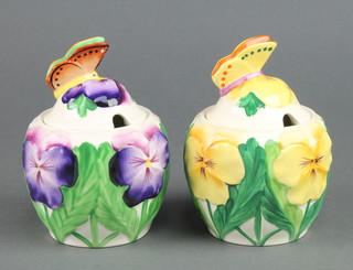 A pair of Minton Art Deco style preserve pots with butterfly finials 