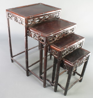 A harlequin nest of four Chinese carved and pierced hardwood interfitting coffee tables, comprising two and two, 28"h x 19" x 13"w, 24"h x 17"w x 12"d, 20"h x 14 1/2" x 10" and 16"h x 11" x 8"  
