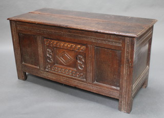 An 18th Century carved oak coffer of panelled construction with hinged lid, the interior lined with 1861 editions of the Illustrated London News 26"h x 49"w x 21"d 
