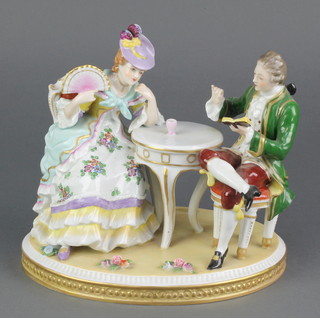 A 20th Century German porcelain figure group of a seated lady and gentleman 10" 