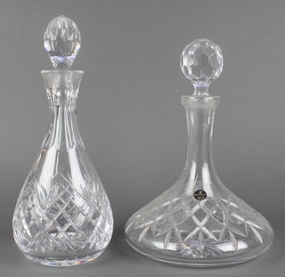 A cut glass ships decanter and stopper 12" and a mallet shaped decanter 12" 