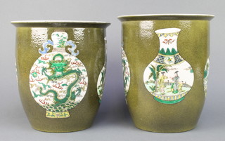 A near pair of 18th Century style Chinese green ground cylindrical jardinieres decorated with panels of vases bearing a 6 character mark to the base 10" 