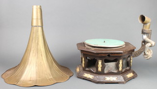 A reproduction horn gramophone with pierced embossed brass horn on an octagonal case, the base fitted a Columbia no. 25 gramophone engine 