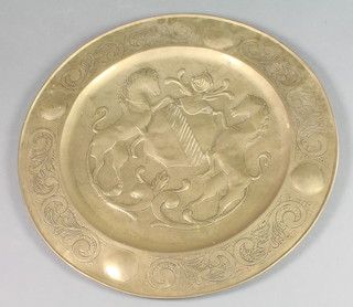 A large Continental embossed brass charger with armorial decoration 30 1/2" diam. 