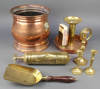 A cylindrical copper planter with brass lion mask handles 9", a large copper and brass chamberstick 9", 3 brass candlesticks, a brass coal shovel and a brass fire extinguisher 