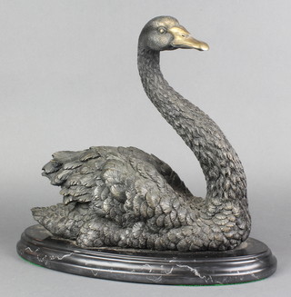 A bronze figure of a swan raised on an oval marble base 12"h x 13"l x 6 1/2"w  