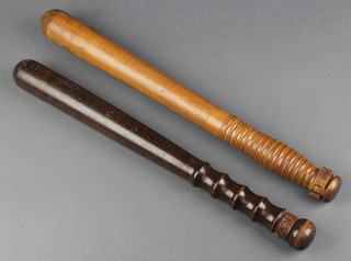 A Military issue wooden truncheon marked WD 19C 15 1/2"l and 1 other turned wooden Police truncheon (thongs missing) 
