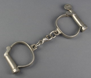 A pair of Hiatt polished steel handcuffs complete with key 