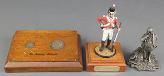 A figure of a standing Royal Marine 5", a Franklyn Mint Dickens museum Samuel Pickwick figure 3 1/2", a George V sixpence and a George VI florin mounted in wooden plaque marked In Loving Memory 