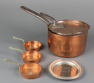 A 19th Century circular copper sauce pan with polished steel handle 7", some dents, 3 copper and brass brandy saucepans marked names of pubs, a circular aluminium coaster marked Gordon Russell International Championship Brands Hatch