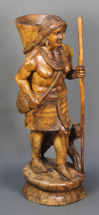 A carved hardwood figure of a standing lady with dog 36"h x 12" diam. 