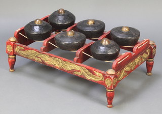 A Chinese rectangular carved hardwood and iron gong stand with 6 detachable dome shaped gongs 11" x 32" x 22"